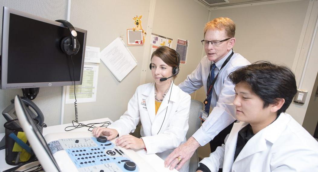 audiology professor and students in lab